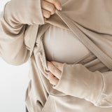 Front of the fabric pulled up while under layer is pulled down to show the functionality for breastfeeding in the Women's French Terry Nursing Hoodie in Almond