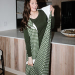 Model wearing Adult Sleep Bag Walker in Gingham Fir over green pajamas