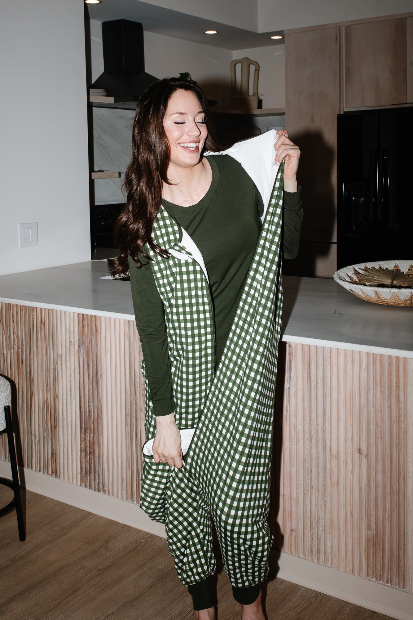 Model wearing Adult Sleep Bag Walker in Gingham Fir over green pajamas