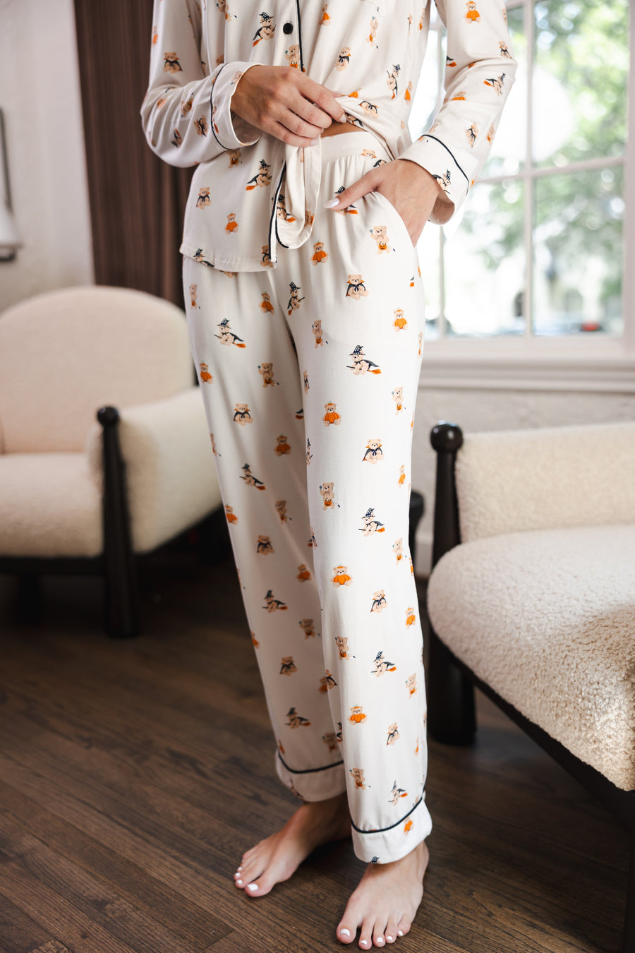 Modal show casing the pajama pockets of Beige Long-Sleeved Women's Pajama Set in Halloween Teddy print