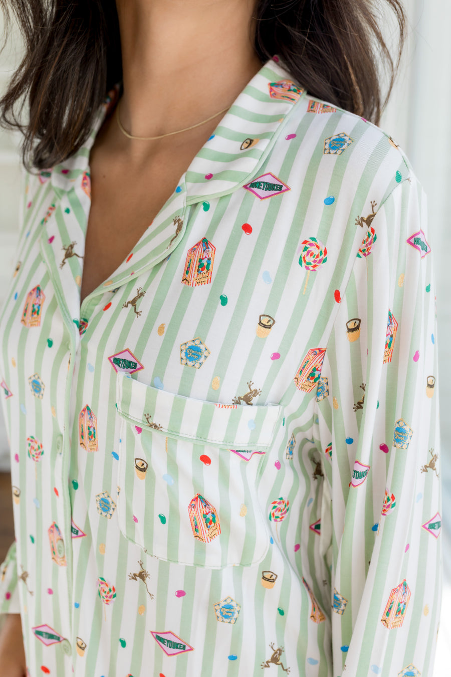 Pocket shirt of Long-Sleeved Women's Pajama Set having colorful Harry Potter patterns on a green and white striped fabric.