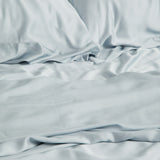 Close up of the Bamboo Sateen Sheet Set in Ice shown on a bed