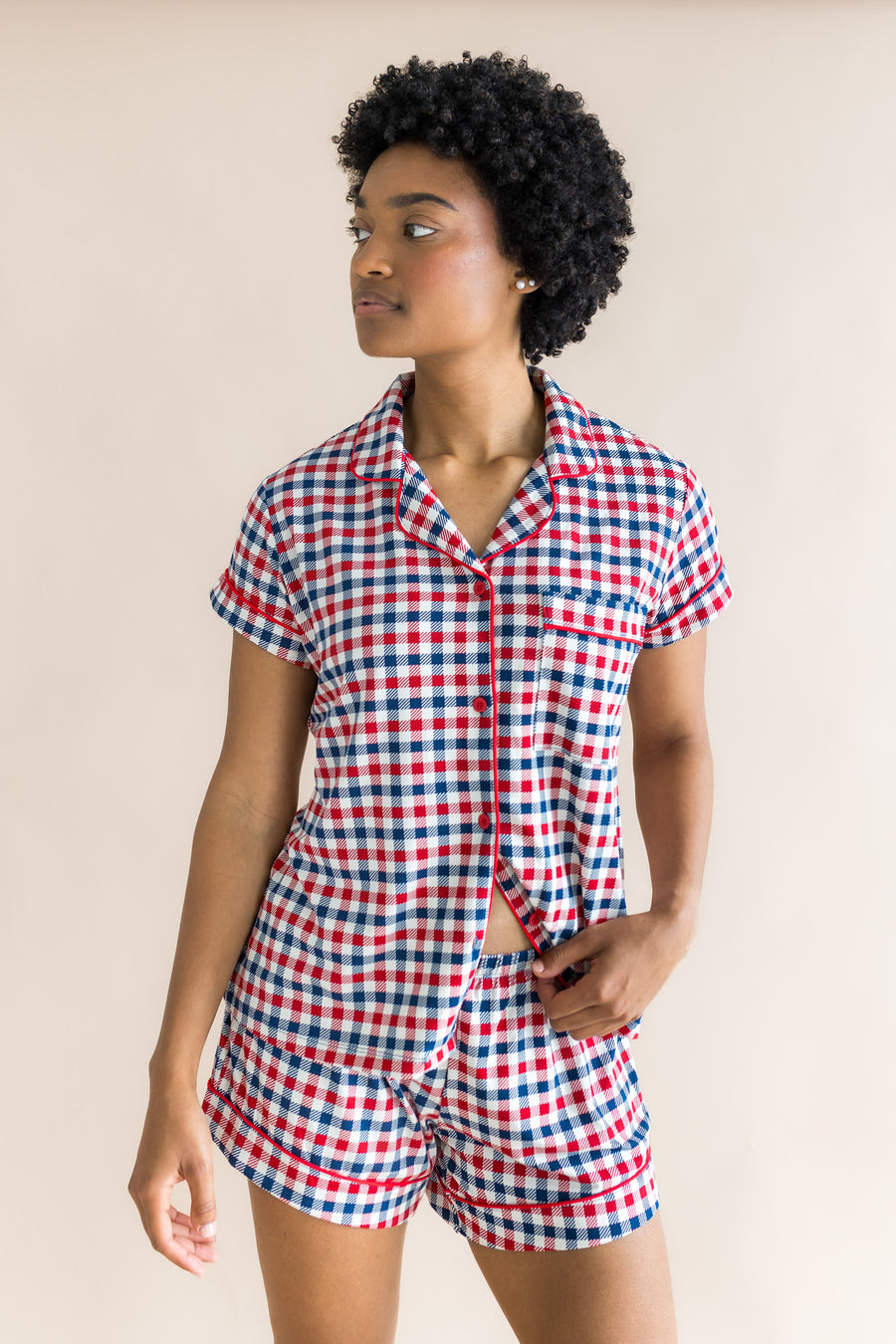 Model looking to the side while wearing the Women's Short Sleeve Pajama Set in Patriotic Gingham