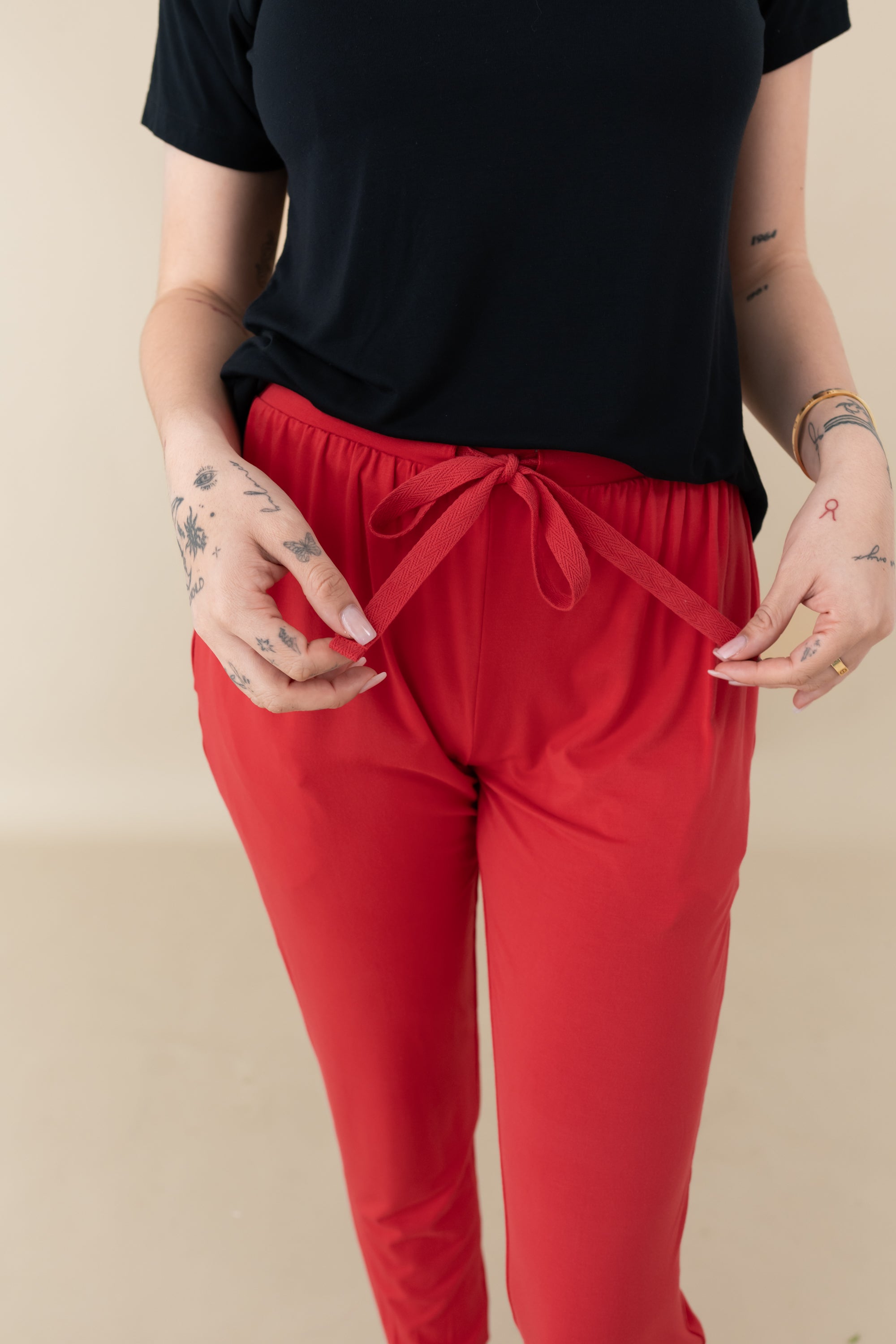 Woman modeling Women's Jogger Pants in Cardinal close up of waist tie