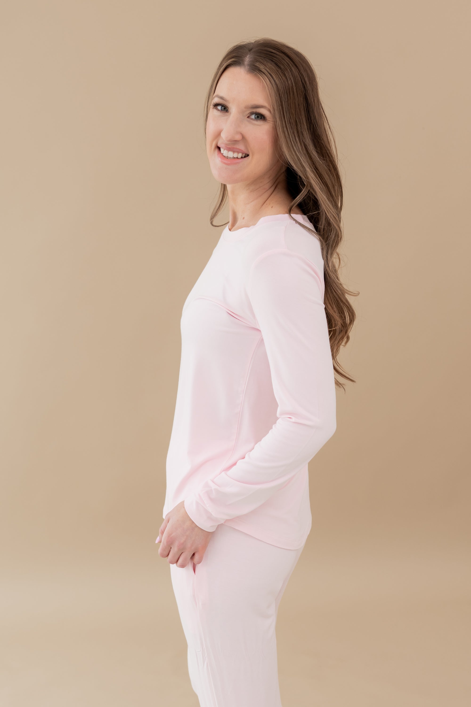 Woman modeling Women's Jogger Pajama Set in Sakura showing sides of pajama with pockets