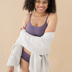 Woman wearing Currant Bralette and Briefs wrapped in Chunky Knit Women's Oversized Cardigan in Oat