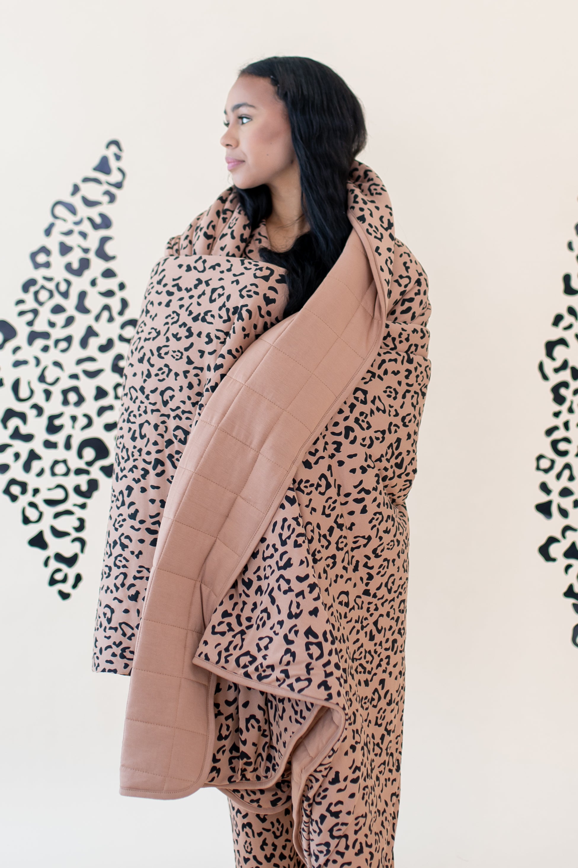 Model wrapped in the Kyte Throw Blanket in Latte Leopard 2.5 TOG
