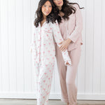 Models wearing Kyte Long Sleeve Women's Pajama Sets in Bow and Blush with Cloud Trim