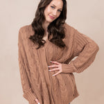 Woman modeling the Chunky Cable Knit Cardigan in Latte