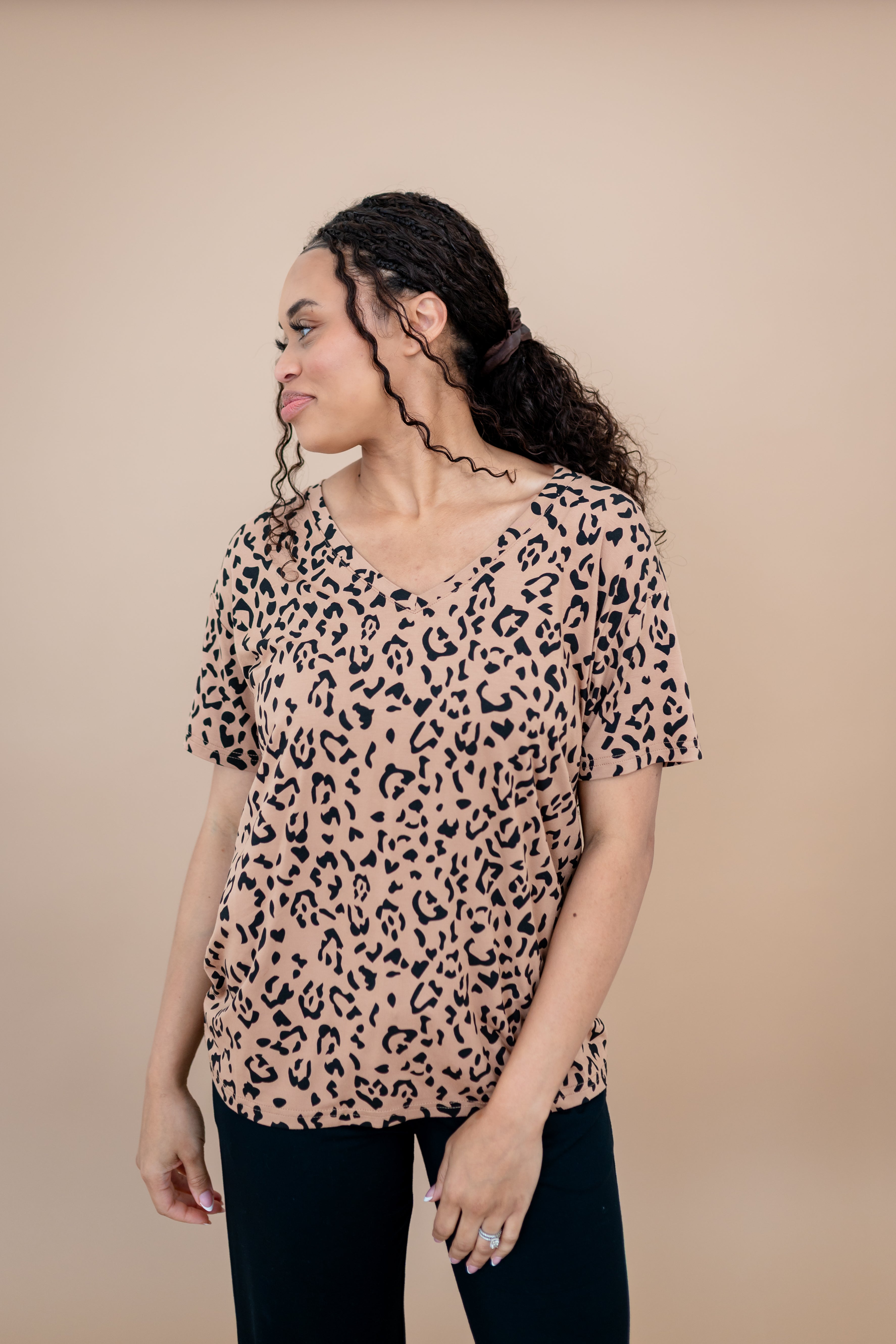 Model looking to the side and close up of the Women's V Neck Tee in Latte Leopard