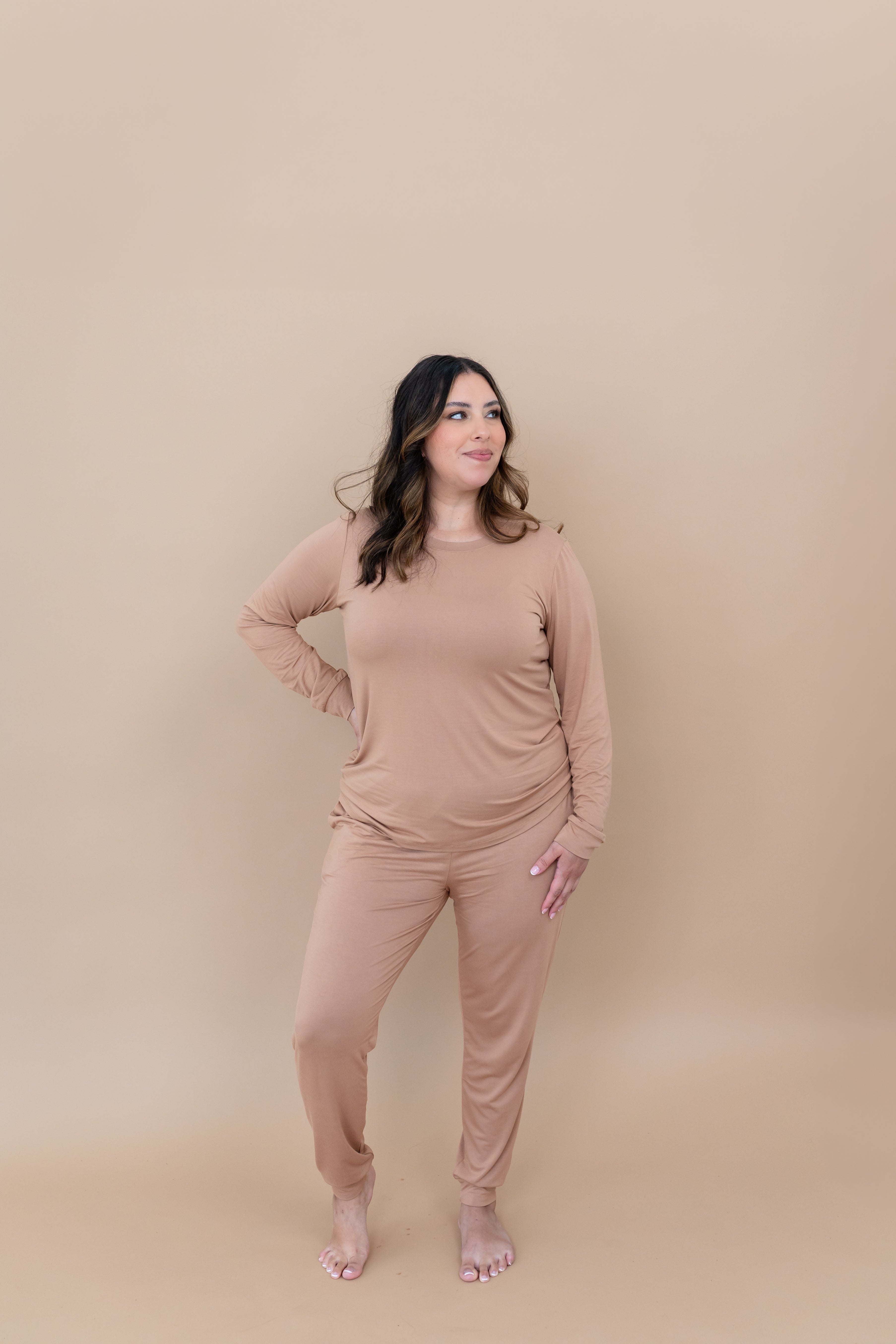Model with hand on her hip while wearing the Kyte Women's Jogger Set in Latte