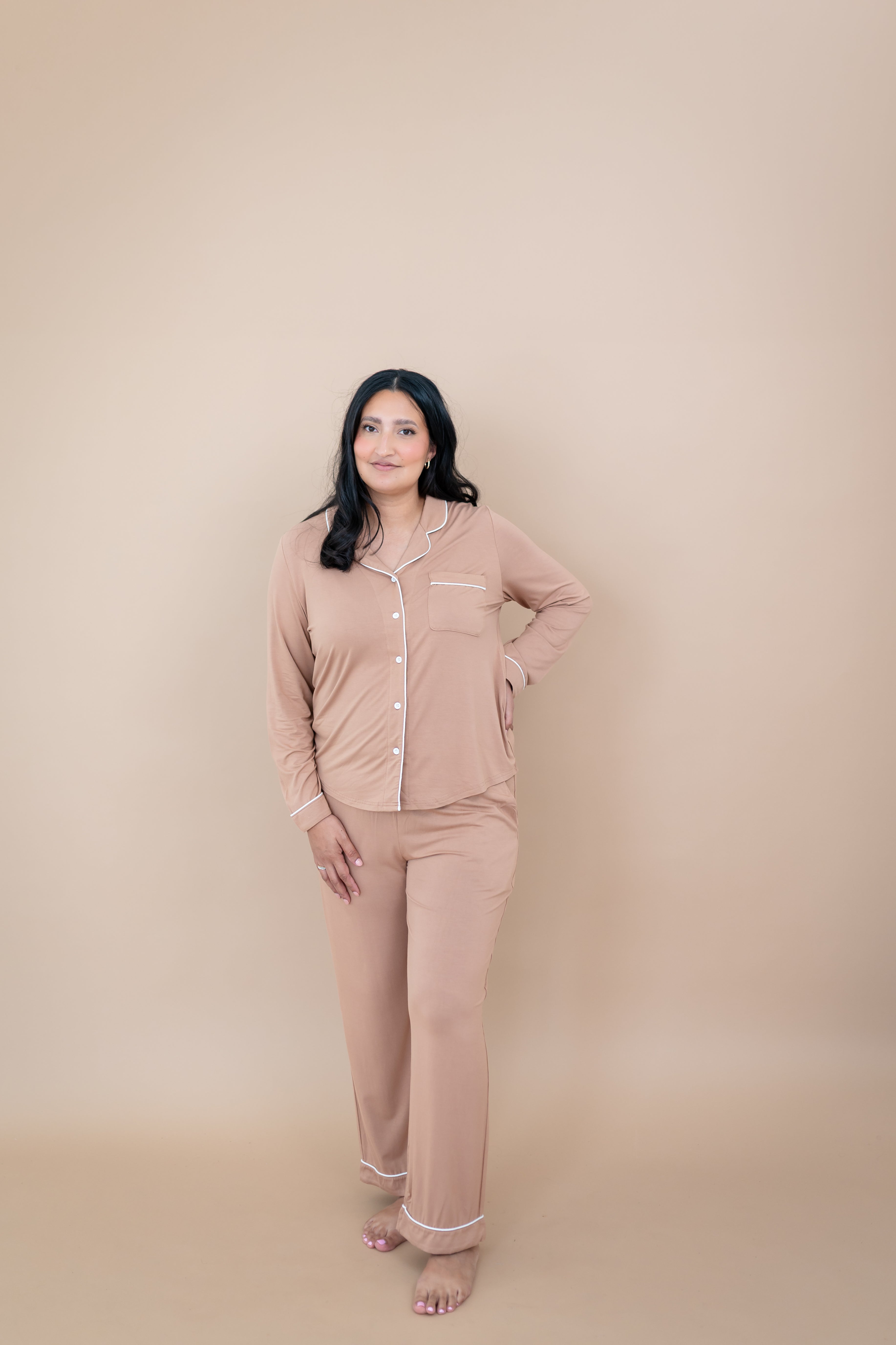 Smiling woman with hand on her hip while wearing the Long Sleeve Pajama Set in Latte