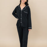 Full length shot of a model wearing the Women's Long Sleeve Pajama Set in Midnight with Cloud Trim