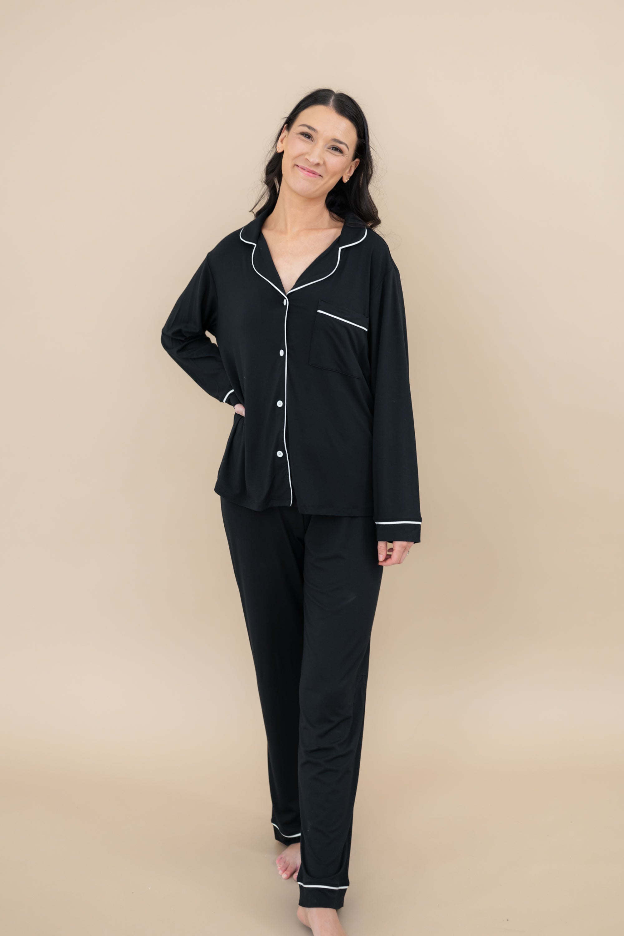 Full length shot of a model wearing the Women's Long Sleeve Pajama Set in Midnight with Cloud Trim