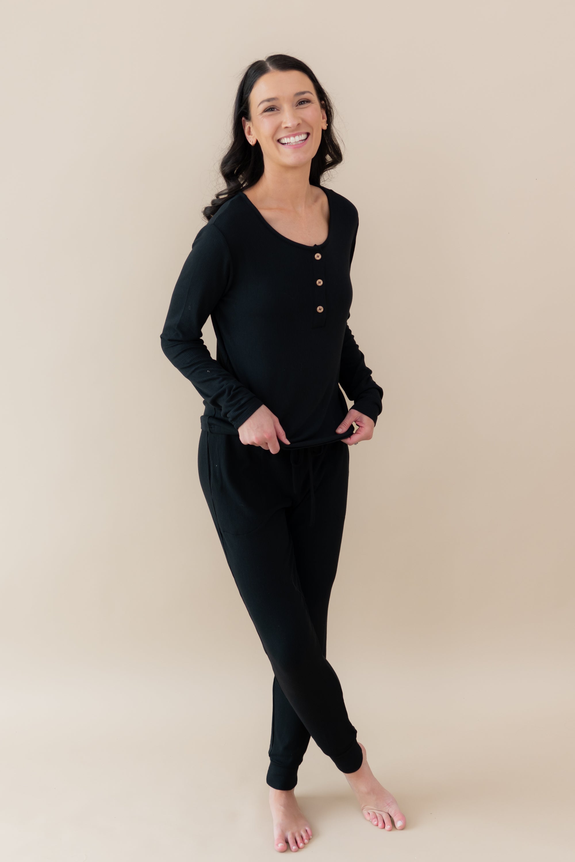 Woman modeling and smiling wearing Women's Ribbed Jogger Pant in Midnight