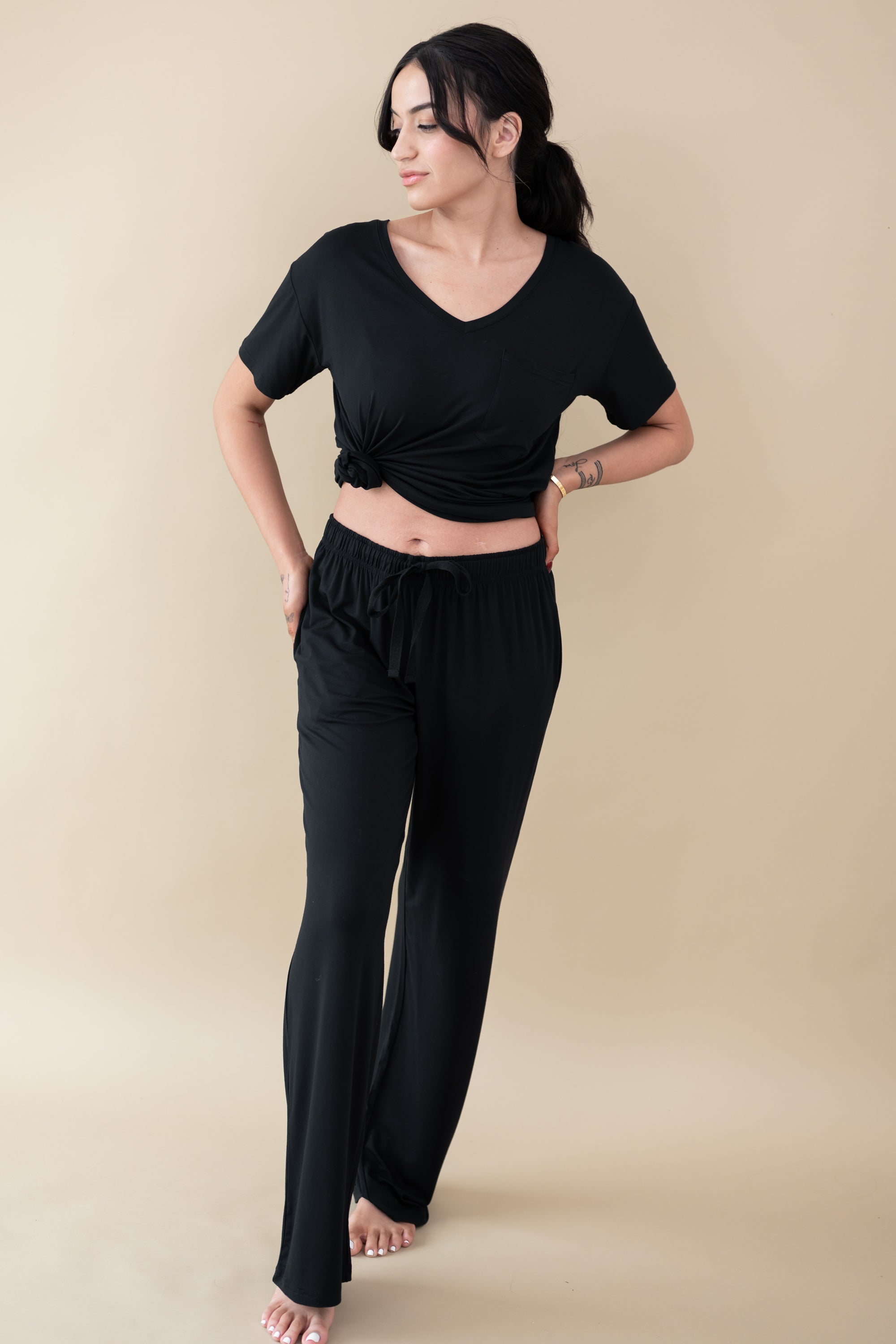 Model wearing Women's Lounge Pants in Midnight paired with a Midnight V-Neck