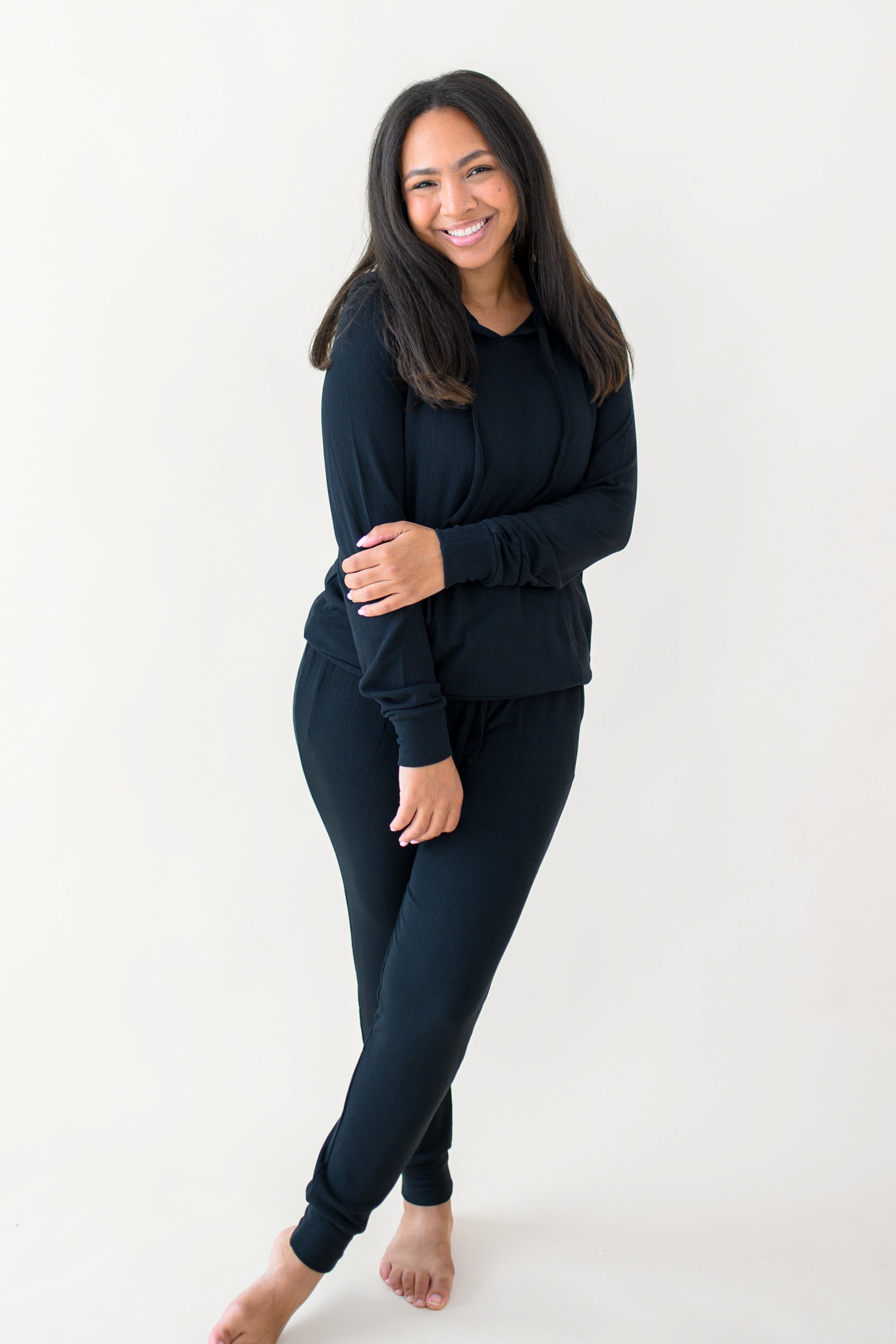 Woman modeling Women's Ribbed Hoodie in Midnight and matching jogger pant
