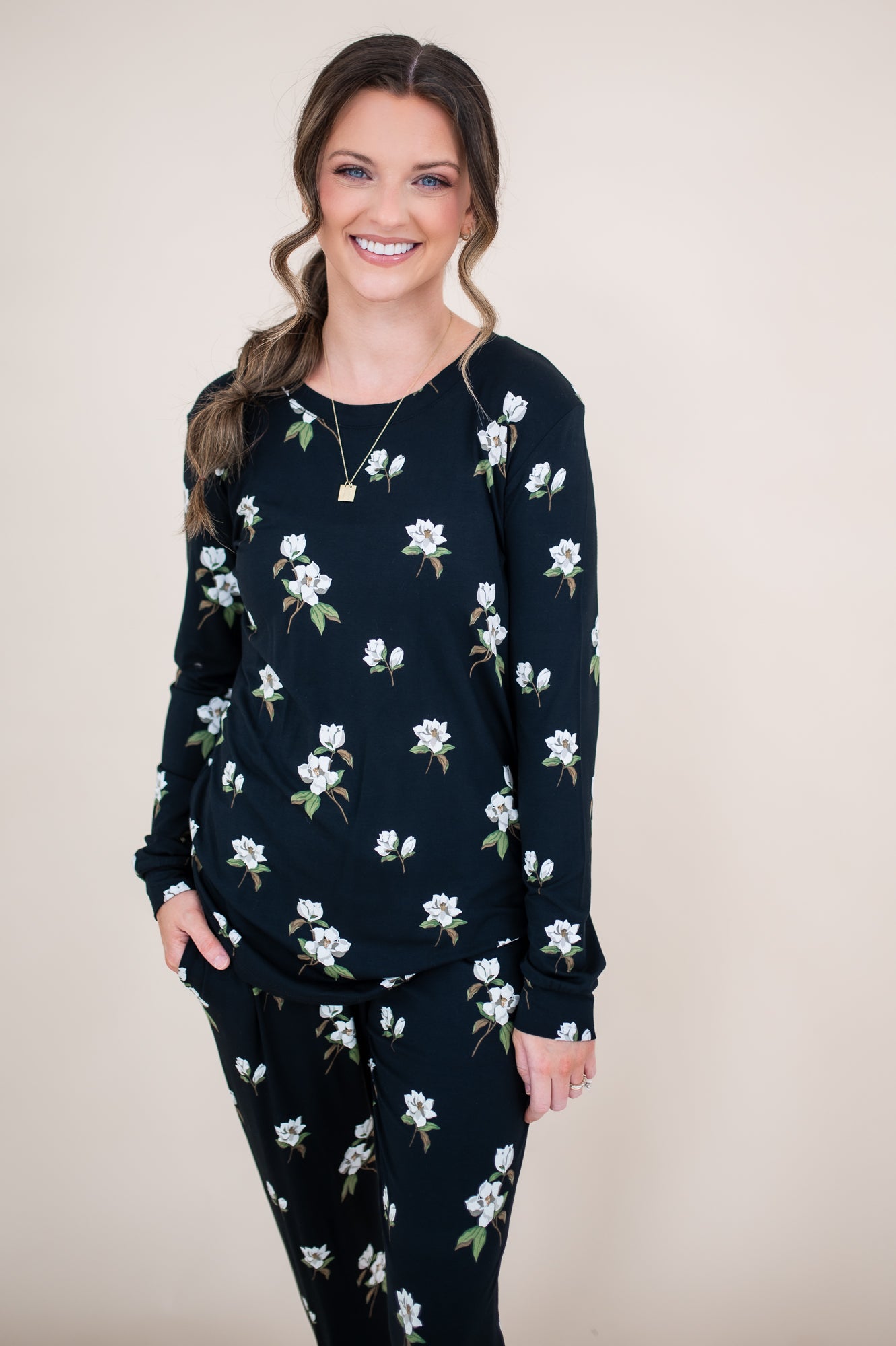 Model smiling at the camera in a close up o the top of the Kyte Women's Jogger Set in Midnight Magnolia