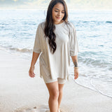 Female walking on the beach wearing the Women’s Biker Short Set in Oat