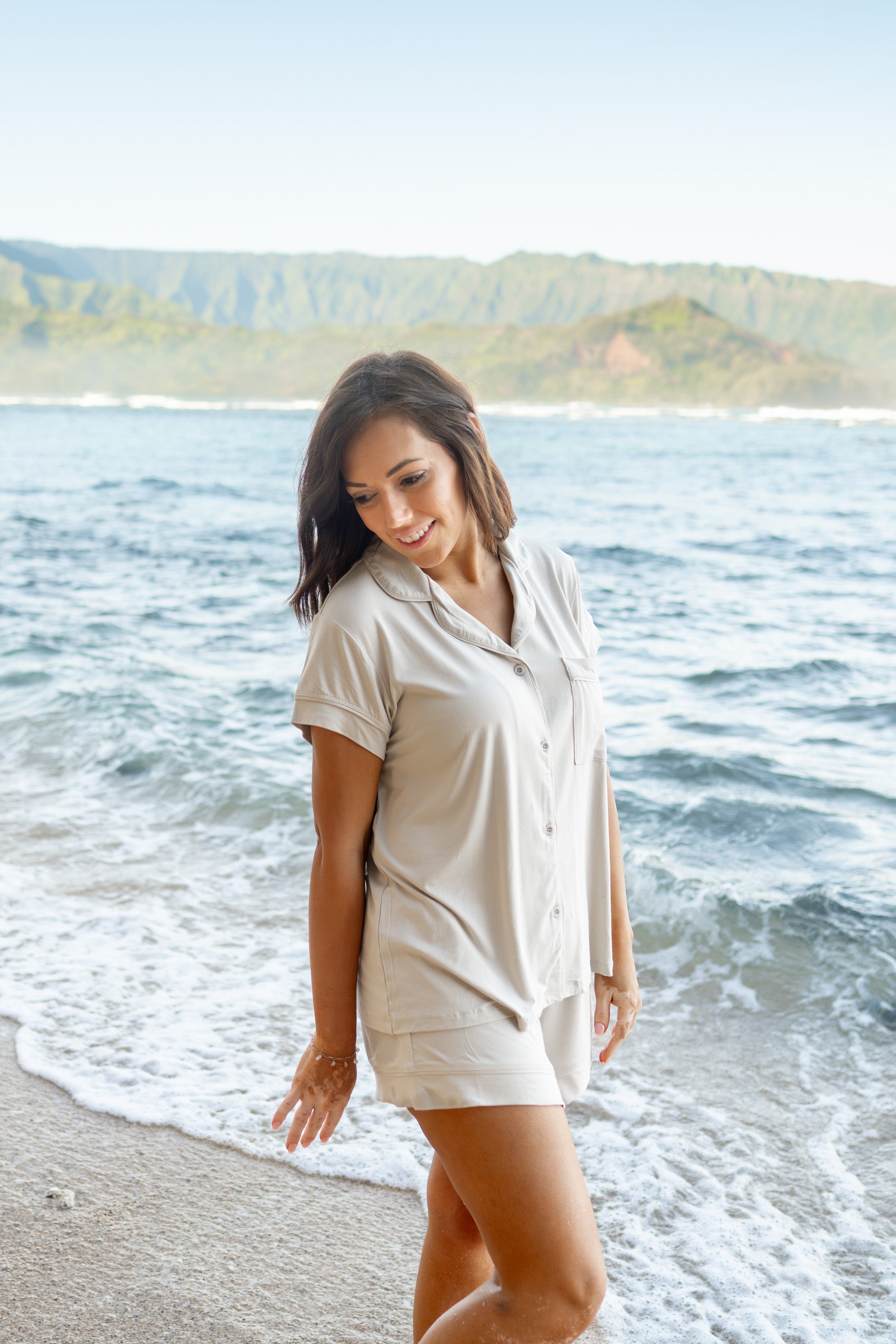 Female model by the ocean wearing Women's Short Sleeve Pajama Set in Oat