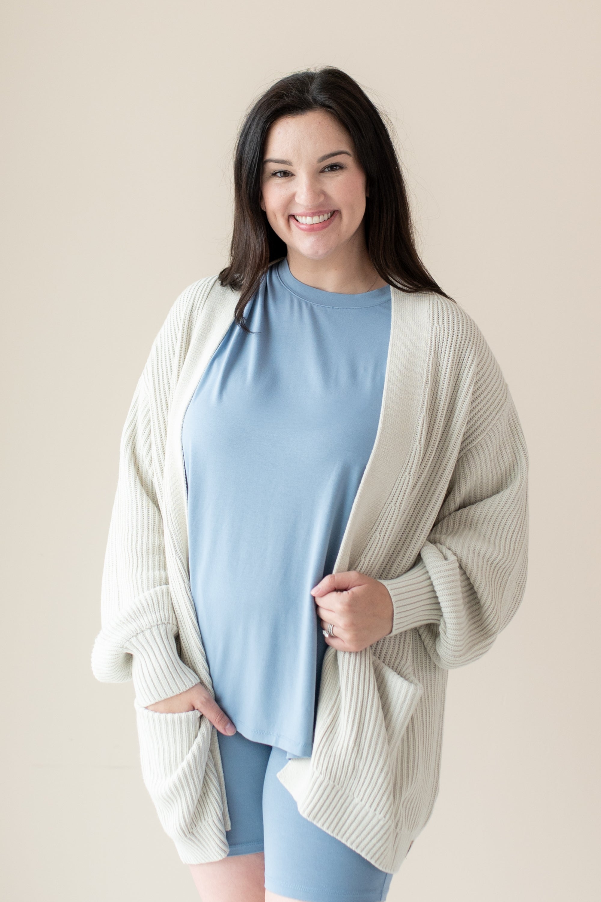 Woman modeling Chunky Knit Women's Oversized Cardigan in Oat and Slate Biker Short Set