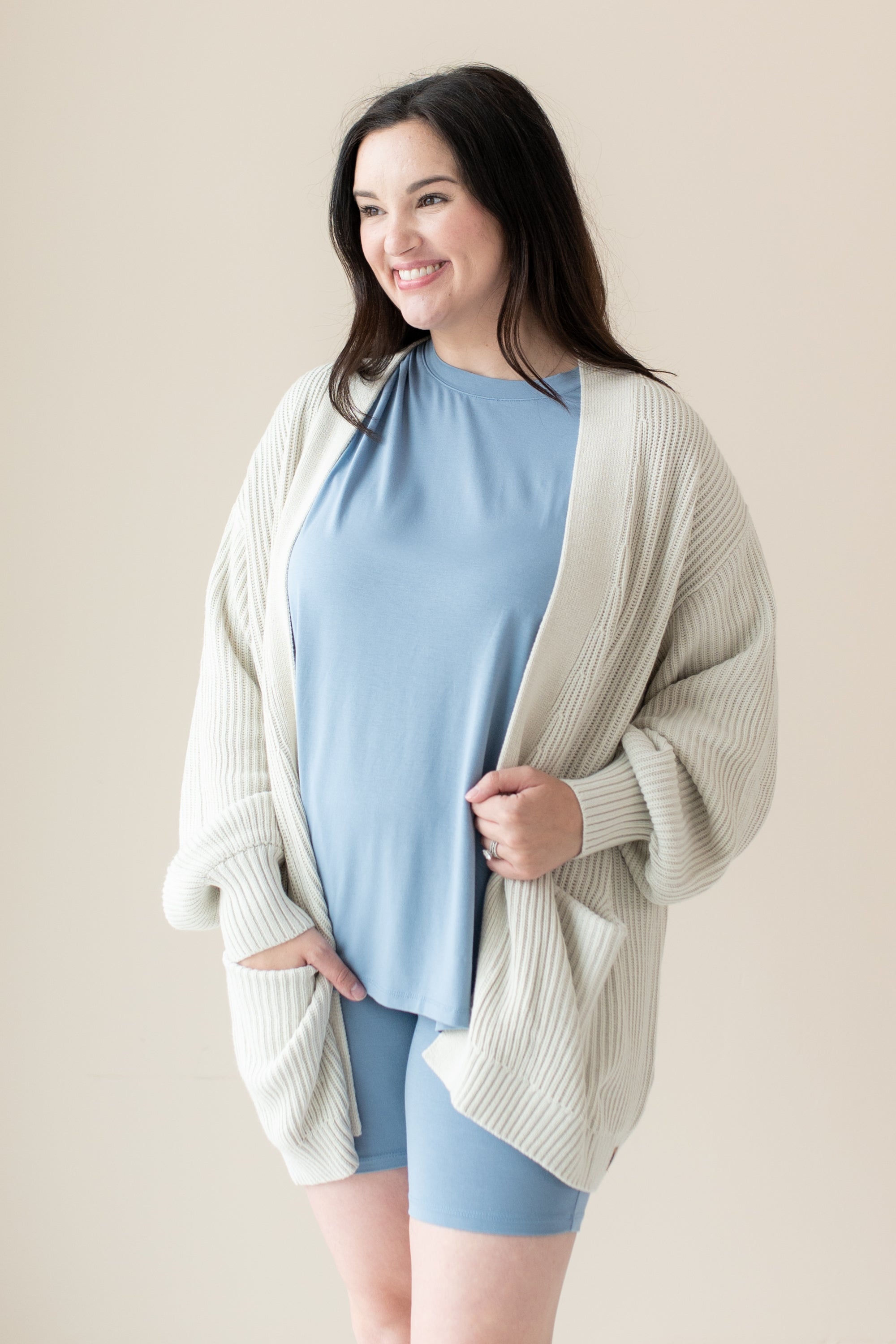 Woman modeling Chunky Knit Women's Oversized Cardigan in Oat and Slate Biker Short Set