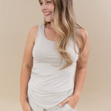 Smiling model wearing the Women’s Tank Set in Oat