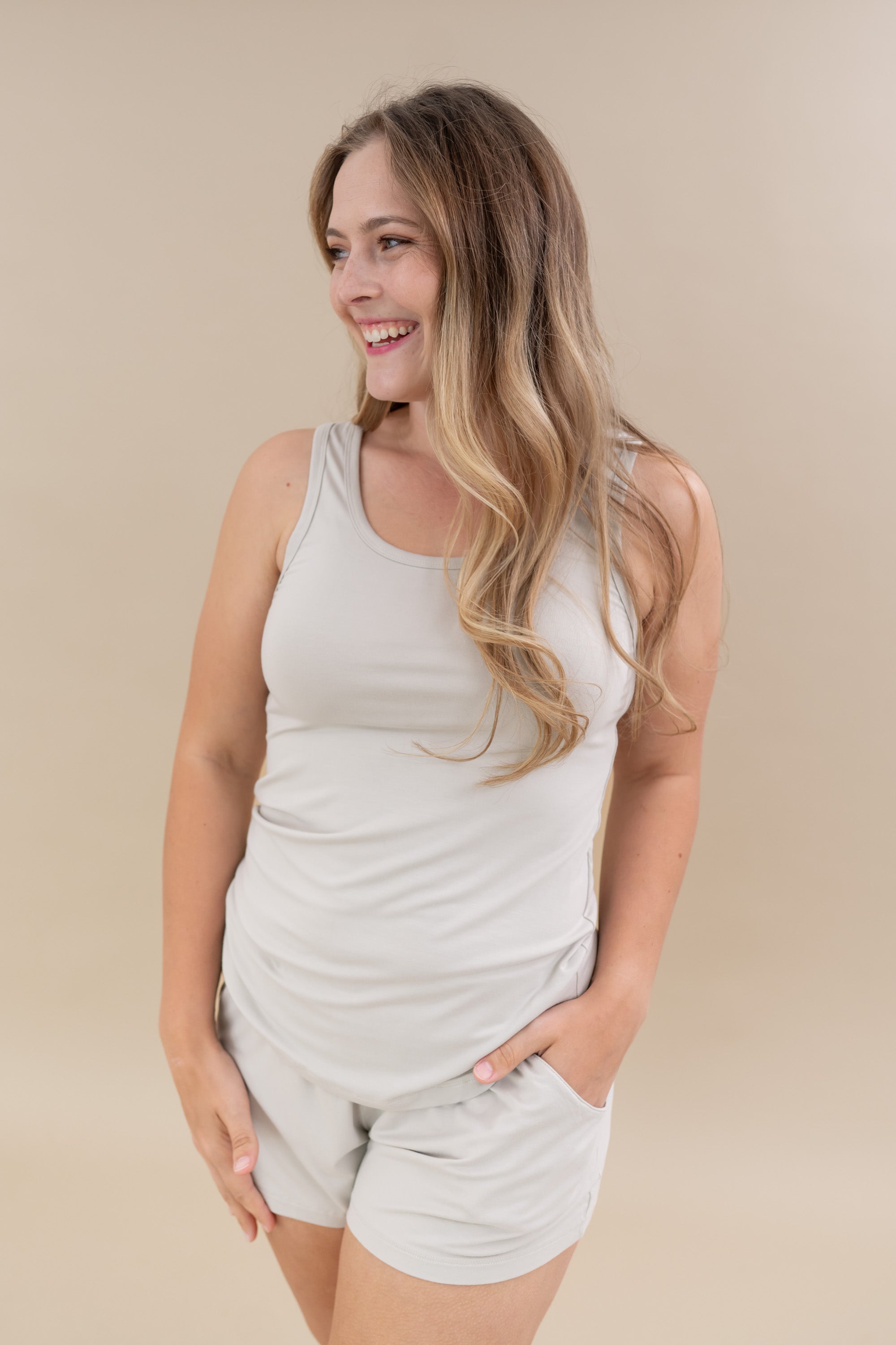 Smiling model wearing the Women’s Tank Set in Oat