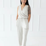 Model walking with both hands in pockets wearing the Women's Jumpsuit in Oat