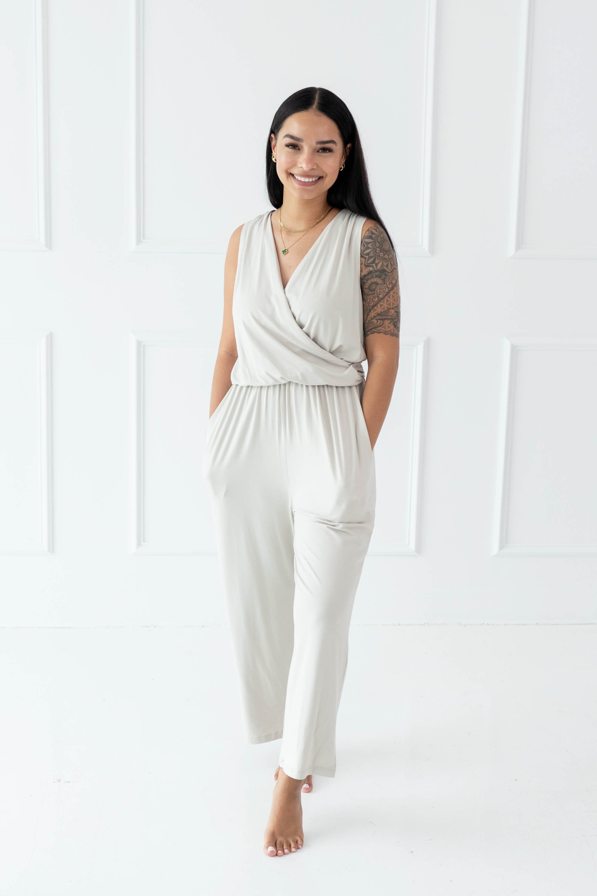 Model walking with both hands in pockets wearing the Women's Jumpsuit in Oat