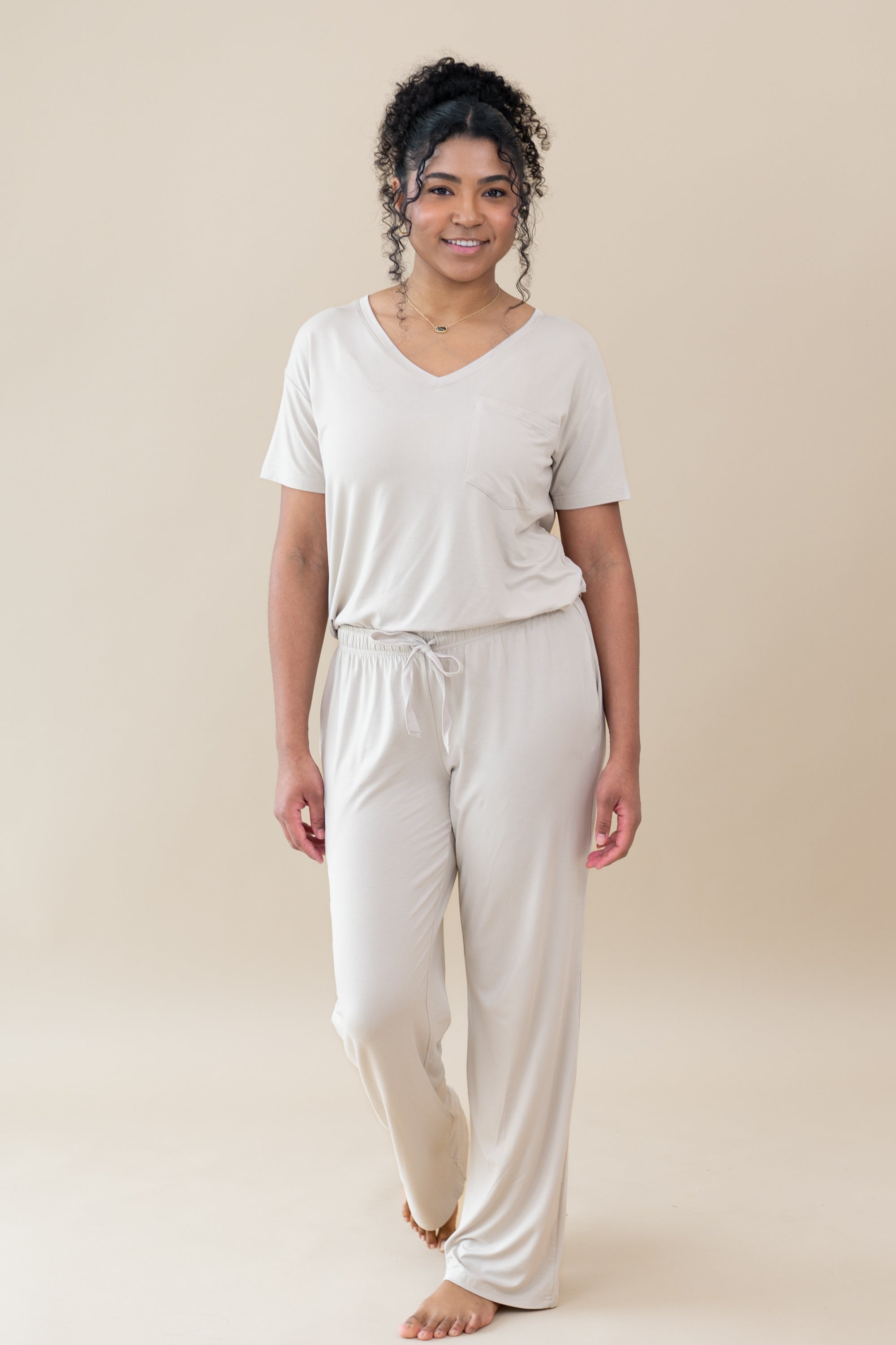 Model wearing the Women's Lounge Pants in Oat paired with an Oat V-Neck