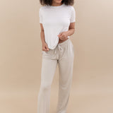 Female wearing the Women's Crew Neck Tee in Snow paired with Kyte Baby's Oat Lounge Pants