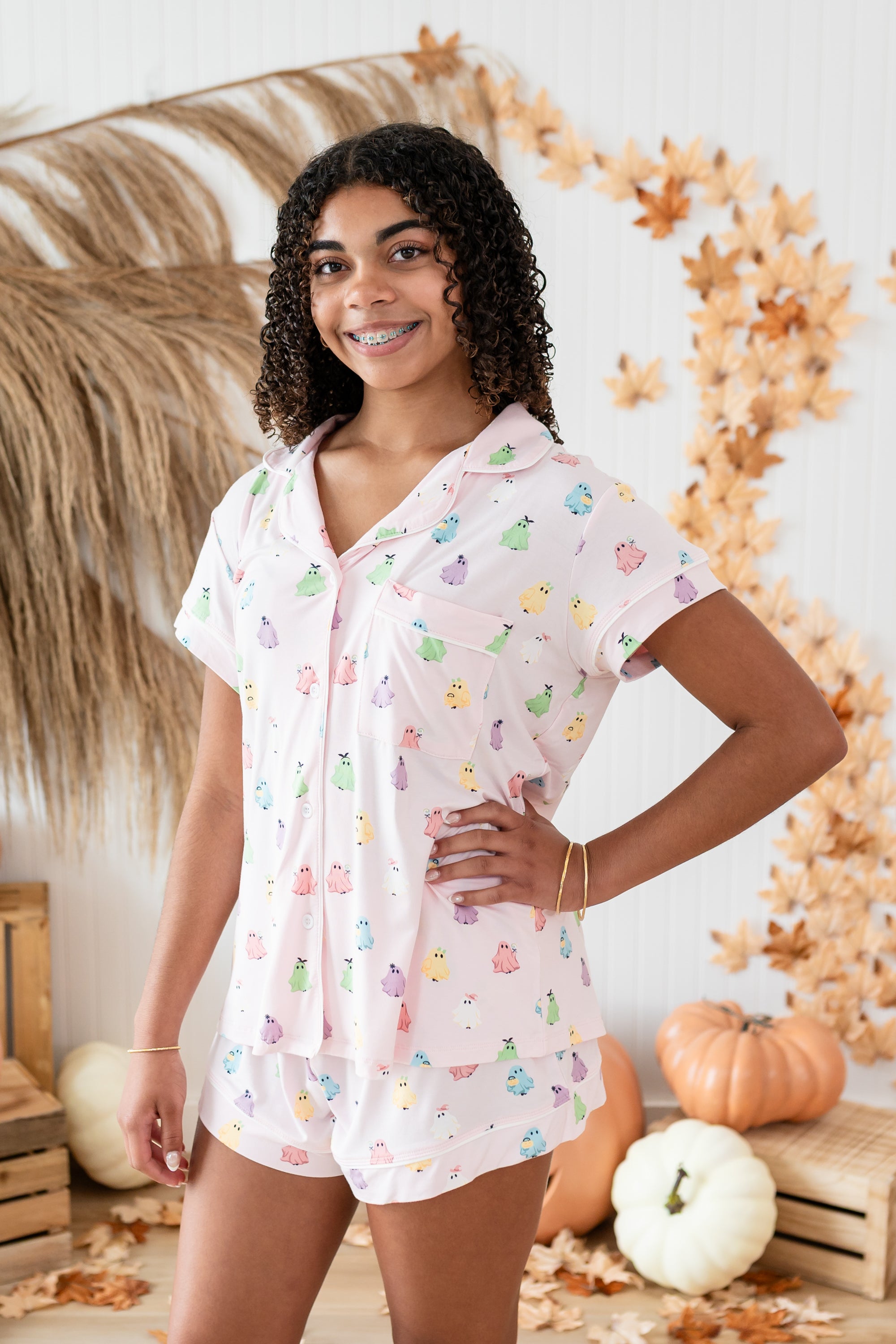 Close up of smiling model in front of Kyte Short Sleeve Pajama Set in Pastel Ghost