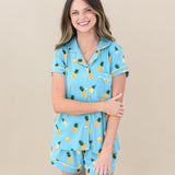 Woman modeling Women’s Short Sleeve Pajama Set in Pineapple. Hand crossed over holding other arm