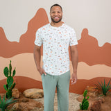 Man modeling Men's Crew Neck Tee in Road Trip and Thyme Lounge Pants with a dessert backdrop