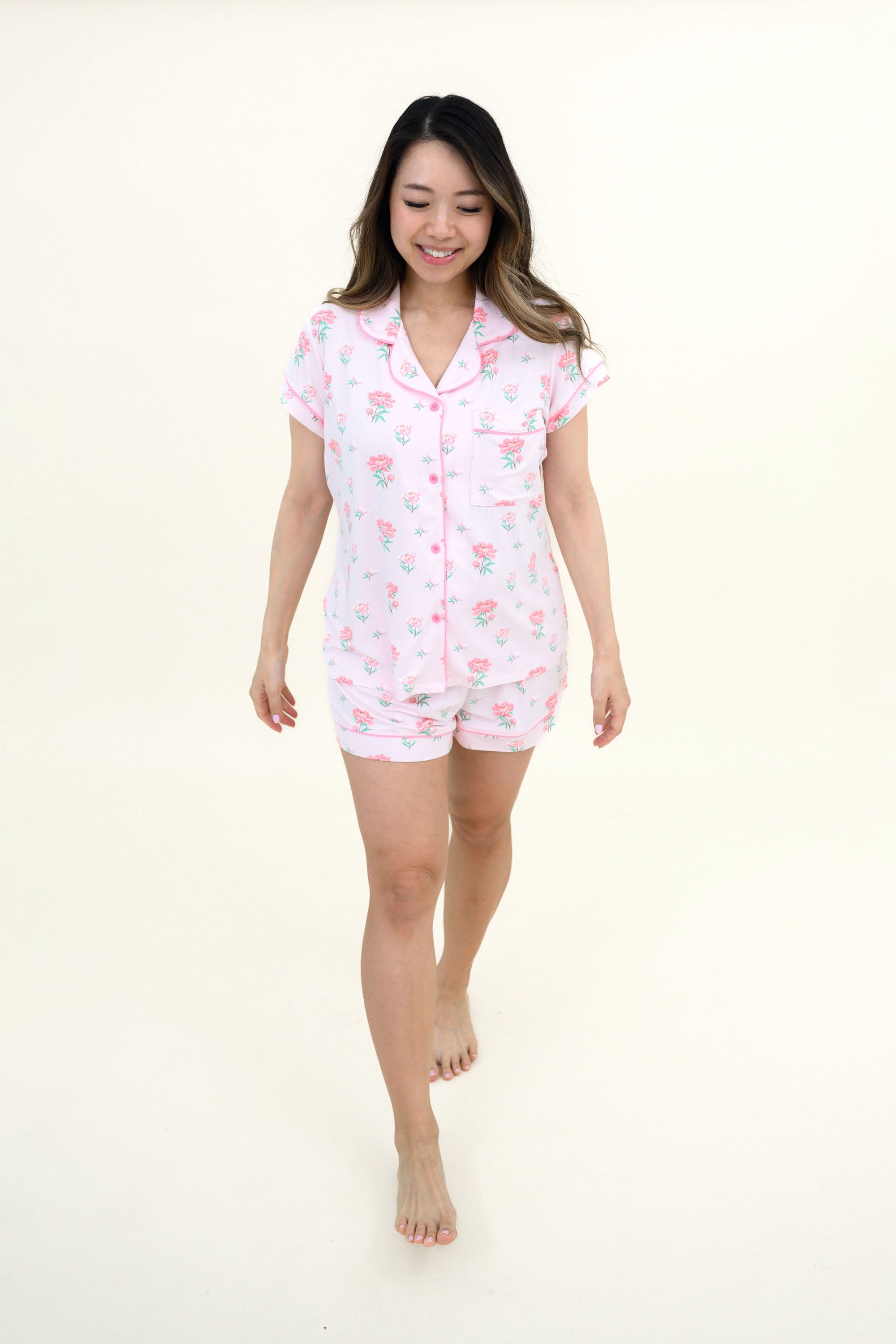 Woman smiling and modeling Women's Short Sleeve Pajama Set in Sakura Peony
