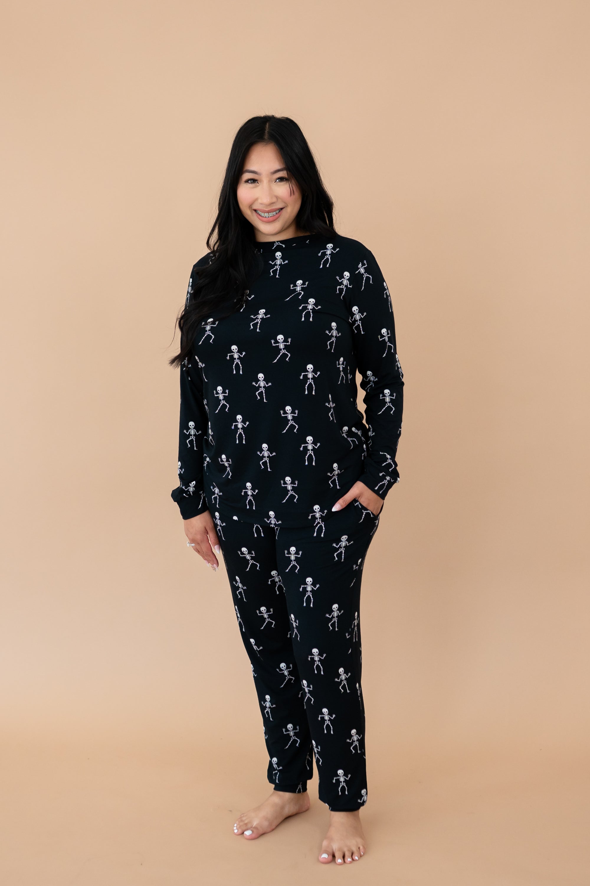 Smiling woman modeling the Kyte Women's Jogger Set in Skeleton
