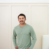 Man modeling Men's Long Sleeve Henley Top in Thyme with jeans