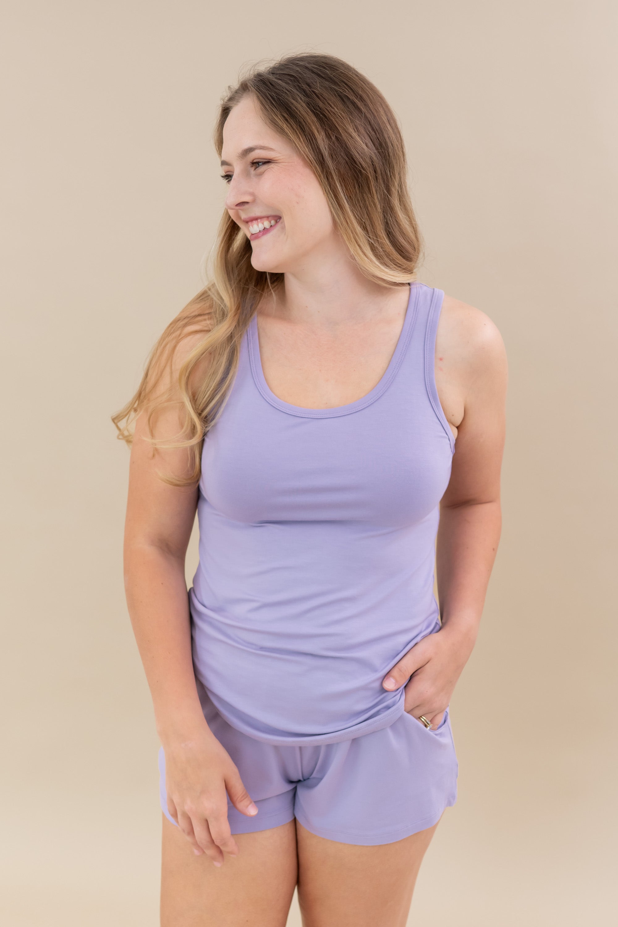 Smiling model wearing the Women’s Tank Set in Taro