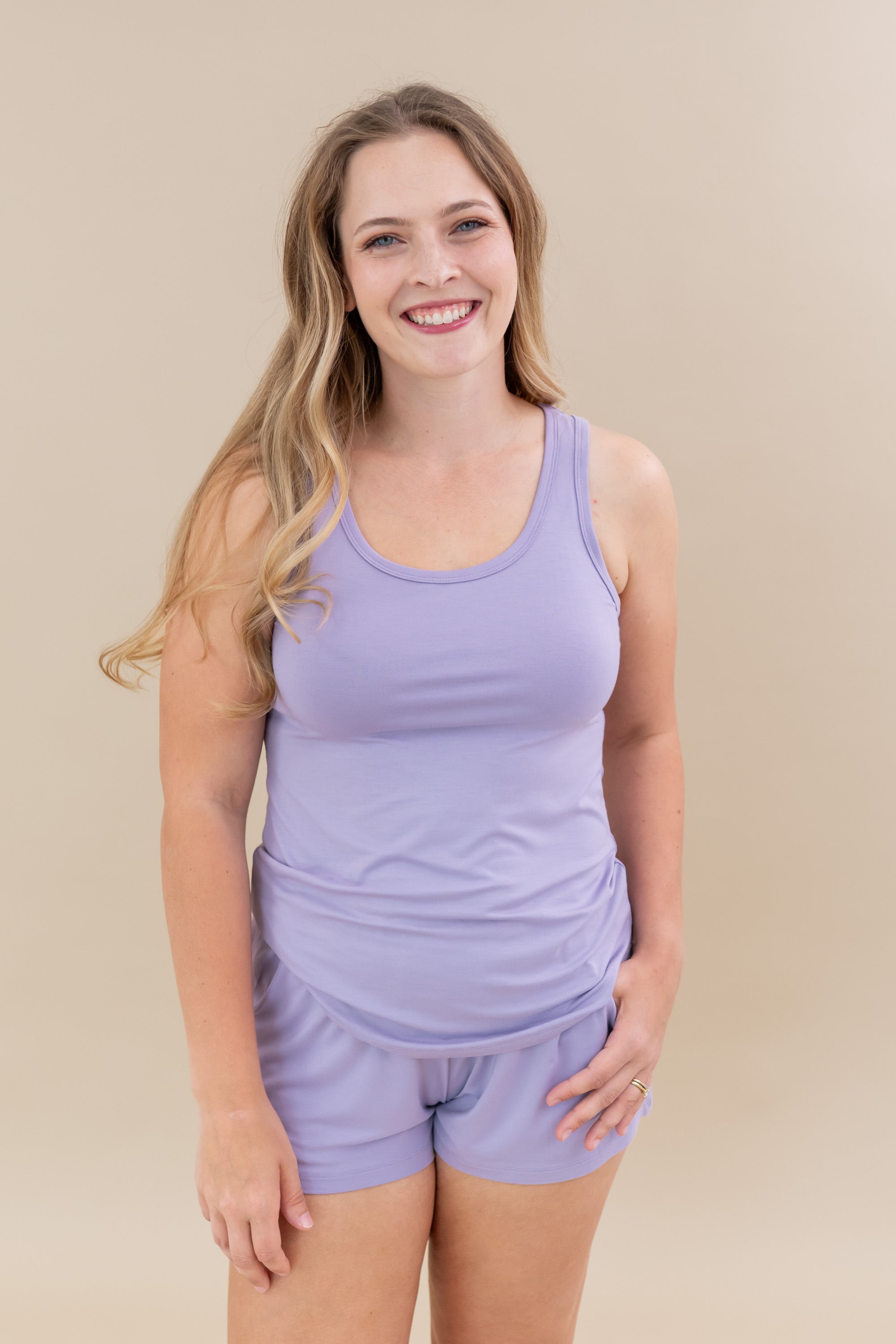 Female model wearing the Women’s Tank Set in Taro