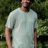 Smiling model wearing the Men's Crew Neck Tee in Thyme