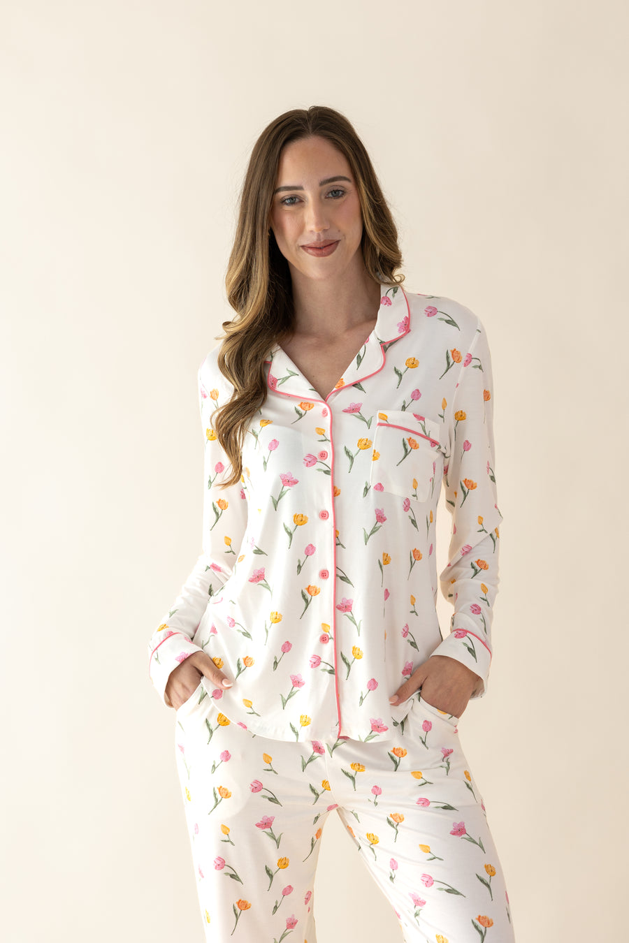 Woman wearing a floral pajama set against a beige background