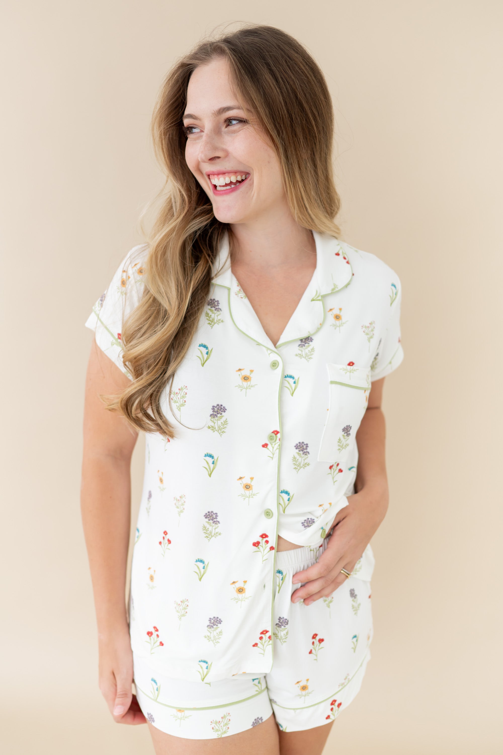 Woman smiling looking off to side wearing Women’s Short Sleeve Pajama Set in Wildflower