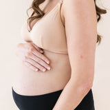 Expectant mother wearing Kyte Baby's Women's Nursing Bra in Chai