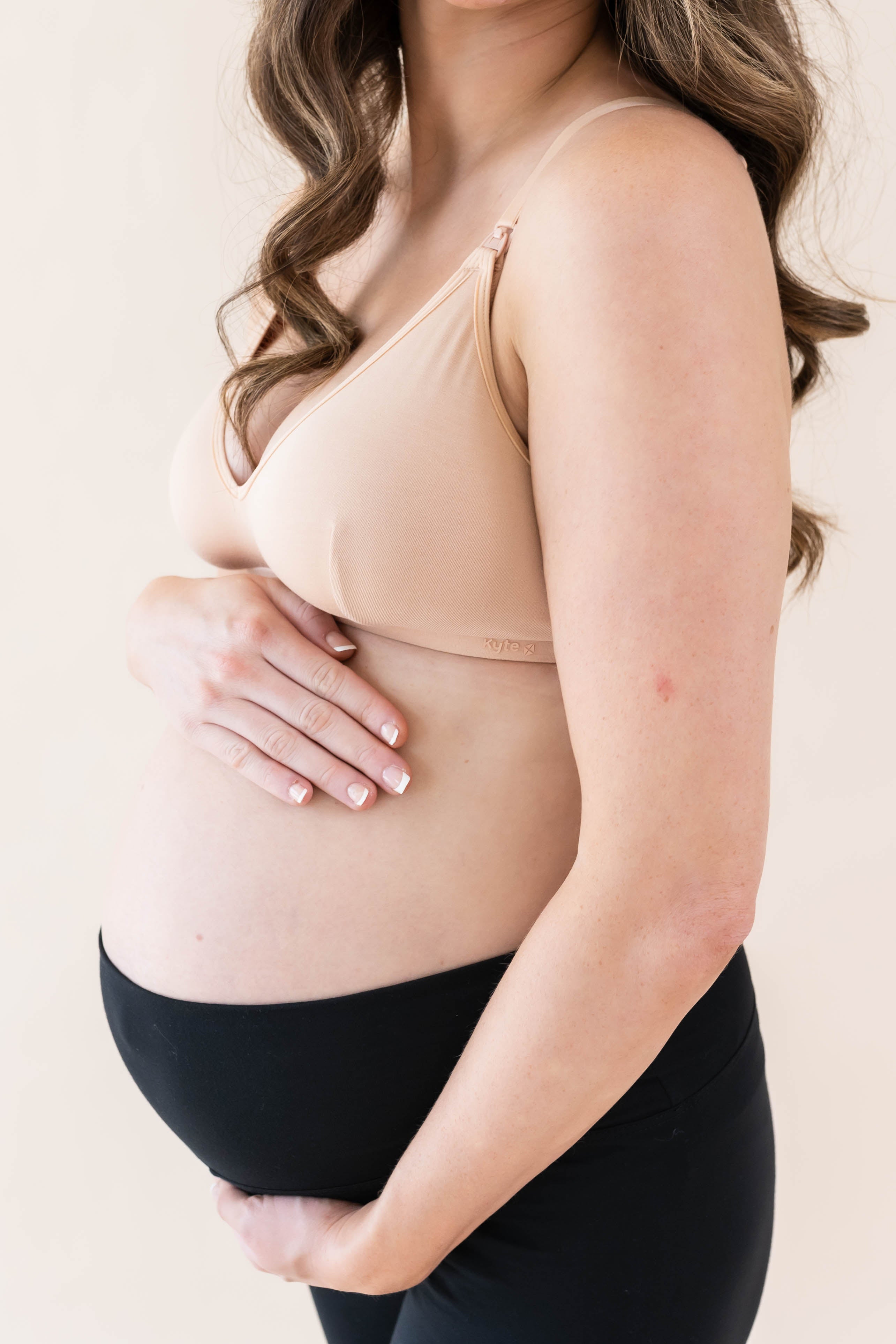 Expectant mother wearing Kyte Baby's Women's Nursing Bra in Chai