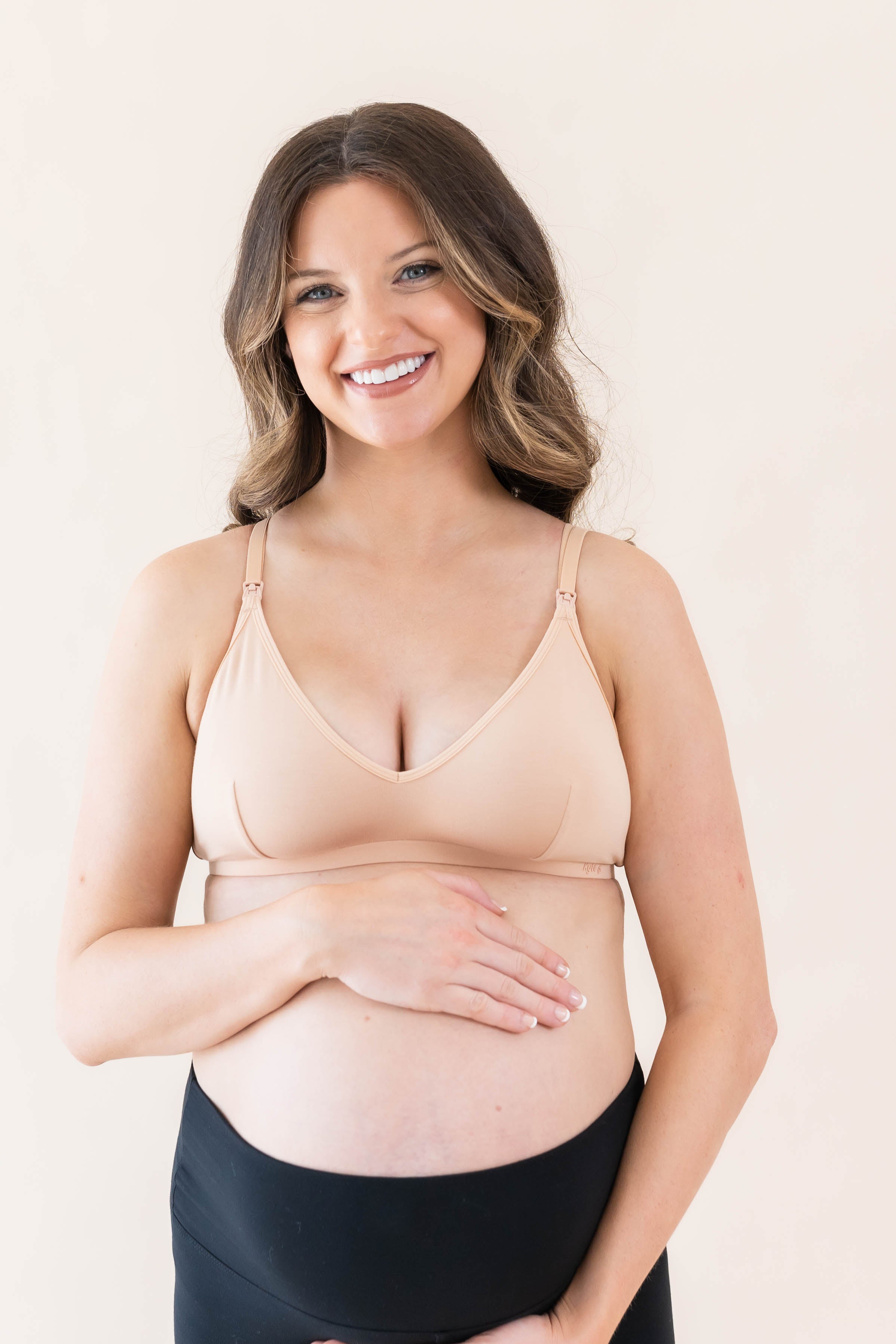 Pregnant woman wearing Kyte Baby's Women's Nursing Bra in Chai