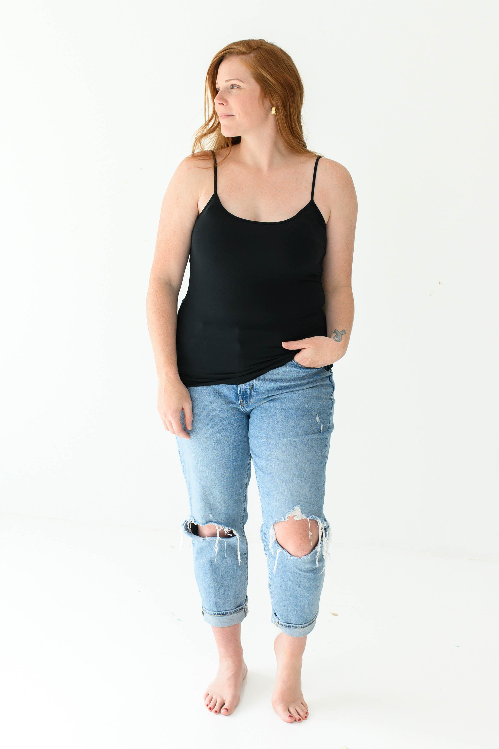 Model in Kyte Baby's Women’s Camisole in Midnight and jeans