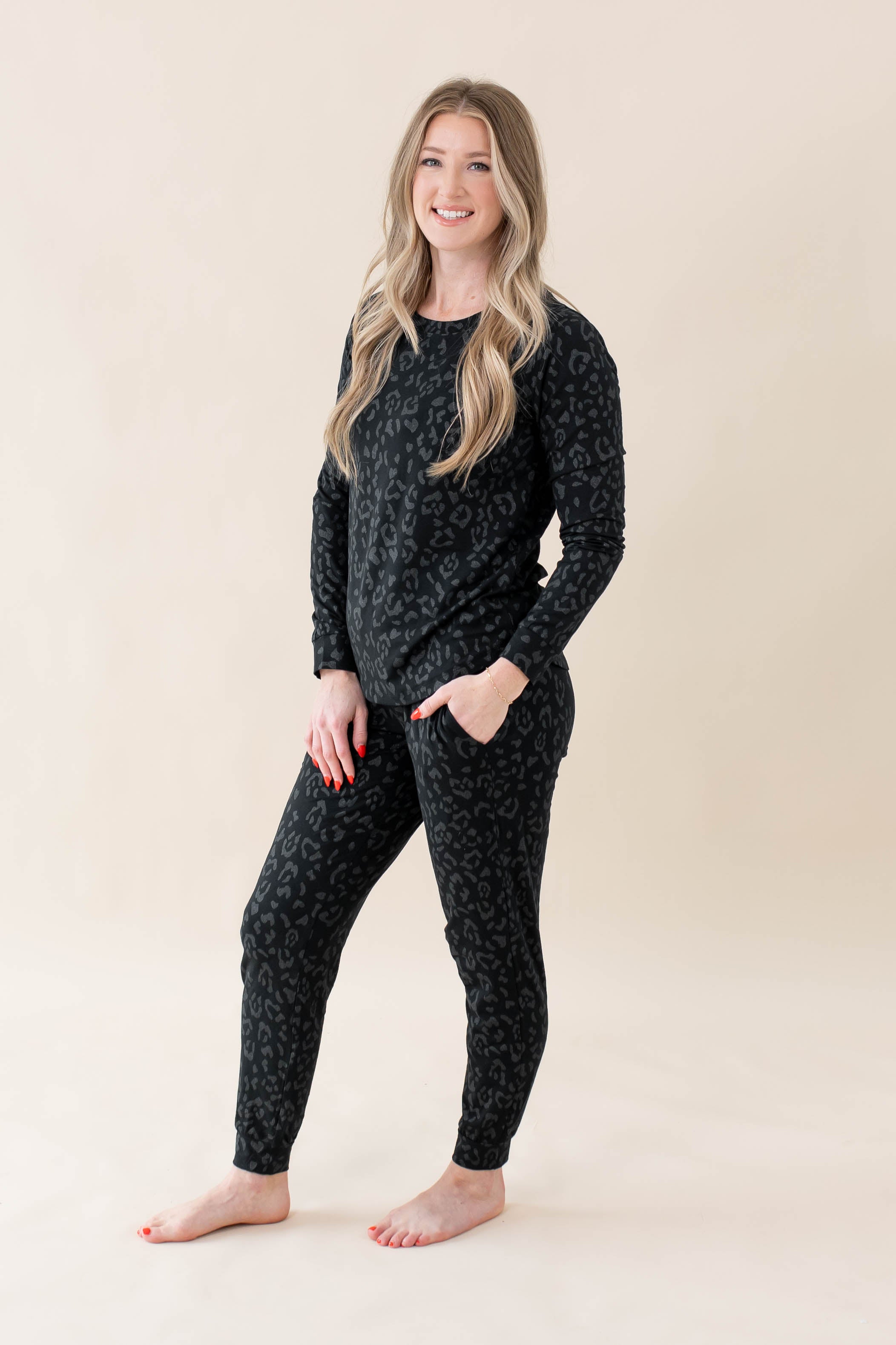 Model wearing Kyte Baby's Women's Jogger Pajama Set in Midnight Leopard