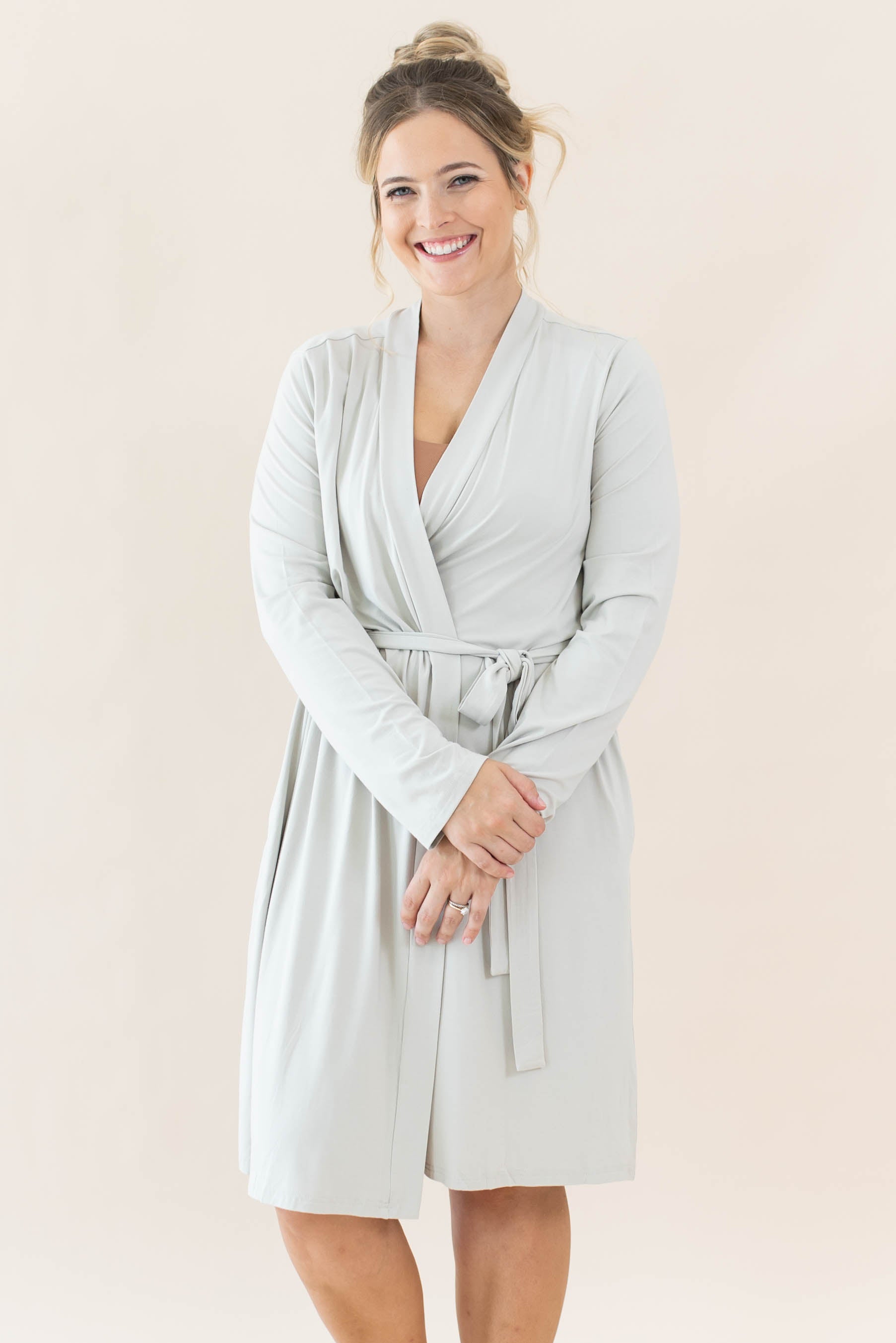 Smiling model wearing the Women’s Lounge Robe in Oat