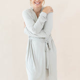 Female hugging herself wearing the Women’s Lounge Robe in Oat